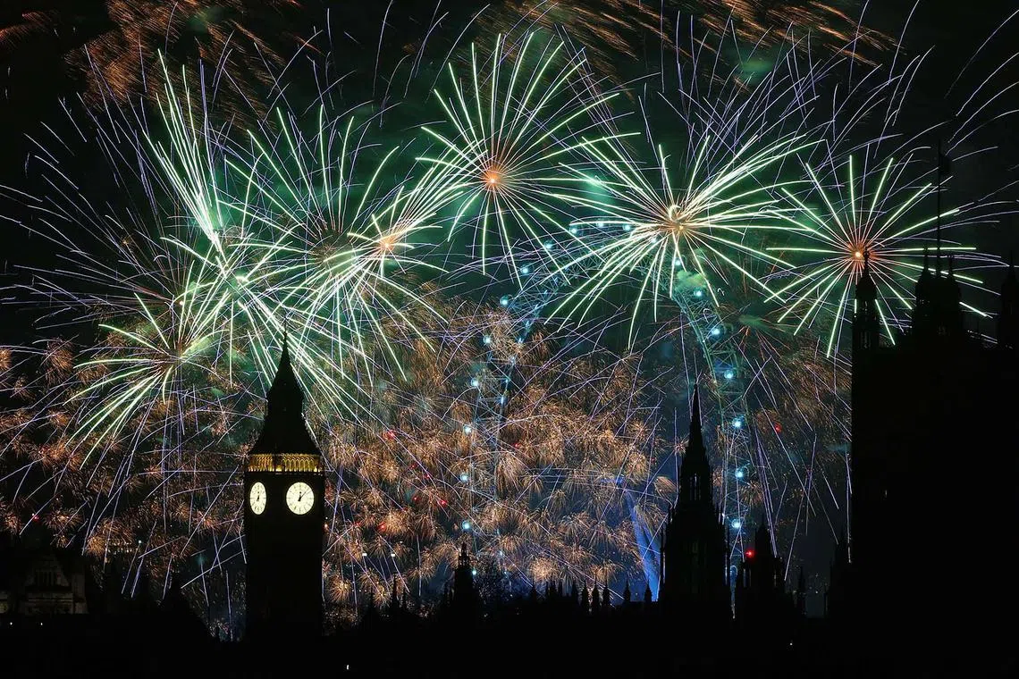 Fireworks exploding around the London Eye and The Elizabeth Tower, commonly known by the name of the clock's bell, "Big Ben", at the Palace of Westminster, home to the Houses of Parliament, in central London, just after midnight on Jan 1, 2024. 