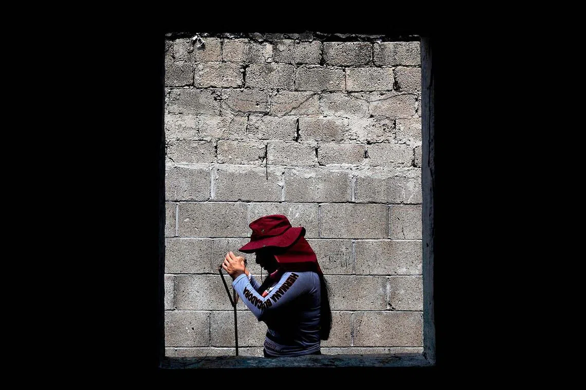 TOPSHOT - A woman member of the collective “Guerreros Buscadores” rests during the search for their missing relatives in an abandoned house in the framework of the International Day of the Disappeared in Tlajomulco de Zúñiga, Jalisco State, Mexico, on August 27, 2024. Jalisco has the highest number of missing persons in Mexico. (Photo by ULISES RUIZ / AFP)