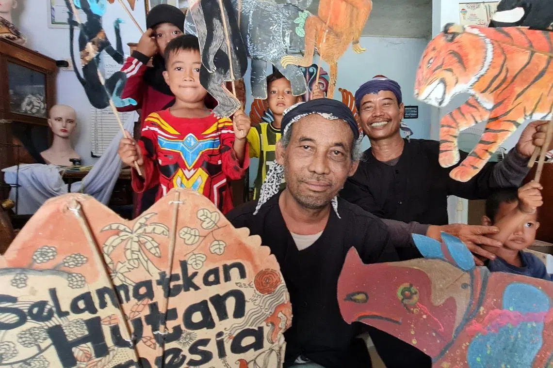 aaletter14 - Schoolteacher turned storyteller, Samsudin, educates children on Indonesia's endangered animals such as Sumatran tiger and Javan rhino through wayang puppets. His friend, Wata, accompanies the wayang sessions by playing the flute.