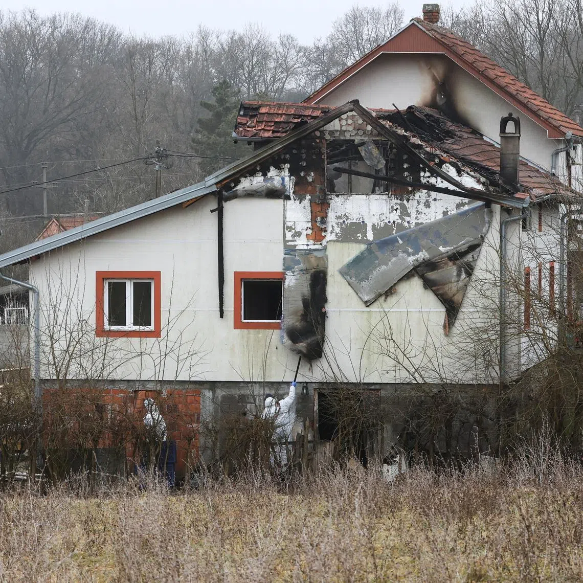 Emergency personnel work at a damaged nursing home that caught fire, outside Belgrade, Serbia, January 20, 2025. REUTERS/Djordje Kojadinovic