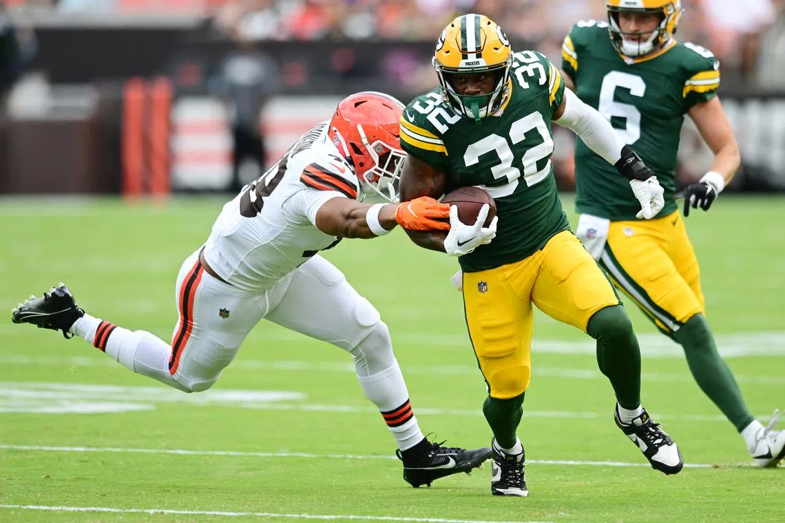 Aug 10, 2024; Cleveland, Ohio, USA; Green Bay Packers running back MarShawn Lloyd (32) runs with the ball as Cleveland Browns linebacker Caleb Johnson (48) defends during the second half at Cleveland Browns Stadium. Mandatory Credit: Ken Blaze-USA TODAY Sports/ File Photo