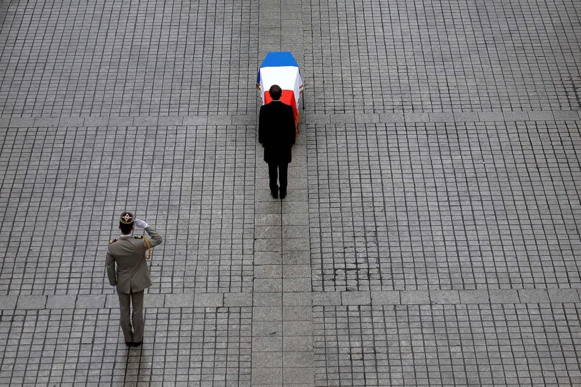 French President Emmanuel Macron pays his respect in front of the flag-drapped coffin of late famous lawyer and former French Justice Minister Robert Badinter, behind France's abolition of the death penalty, during a national tribute ceremony at the Place Vendome in Paris, France, February 14, 2024. REUTERS/Sarah Meyssonnier/Pool TPX IMAGES OF THE DAY