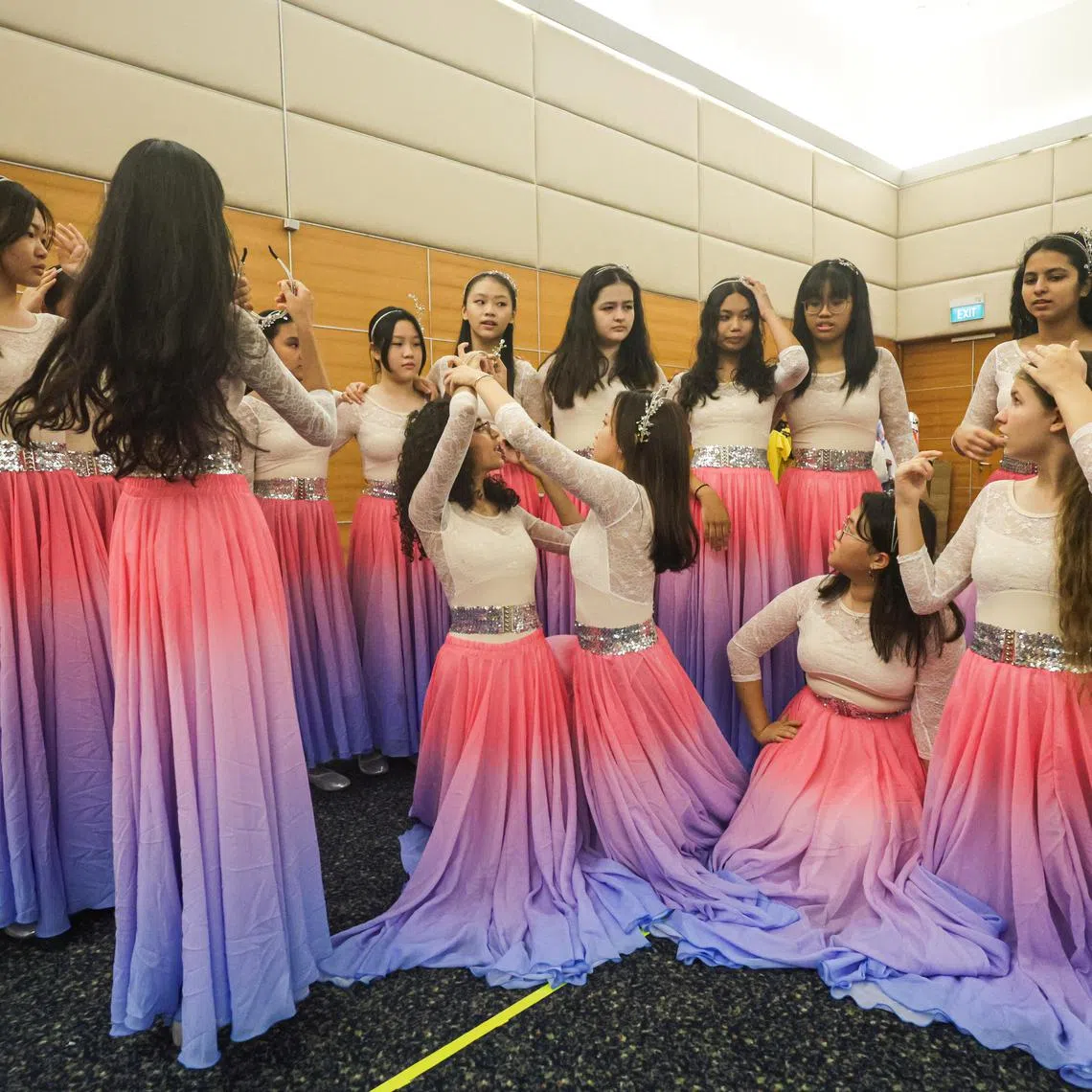 The young ChildAid performers playing characters called The Dream Girls, whose ages range from 10 to 16, trying out their colourful costumes for first time at the SPH News Centre Auditorium.