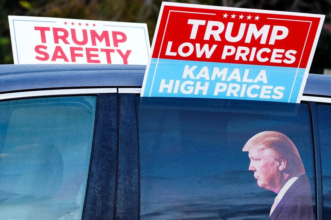 A view shows a vehicle with a sticker depicting Republican presidential nominee and former U.S. President Donald Trump, ahead of a Trump campaign rally in Gastonia, North Carolina, U.S. November 2, 2024. REUTERS/Megan Varner/File Photo