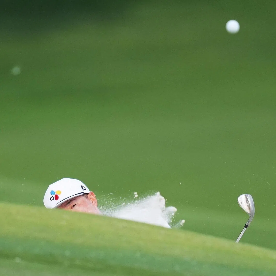 Im Sung-jae blasts out of the bunker on hole 15 in the third round of the Truist Championship on May 9, 2026 at Charlotte, North Carolina.