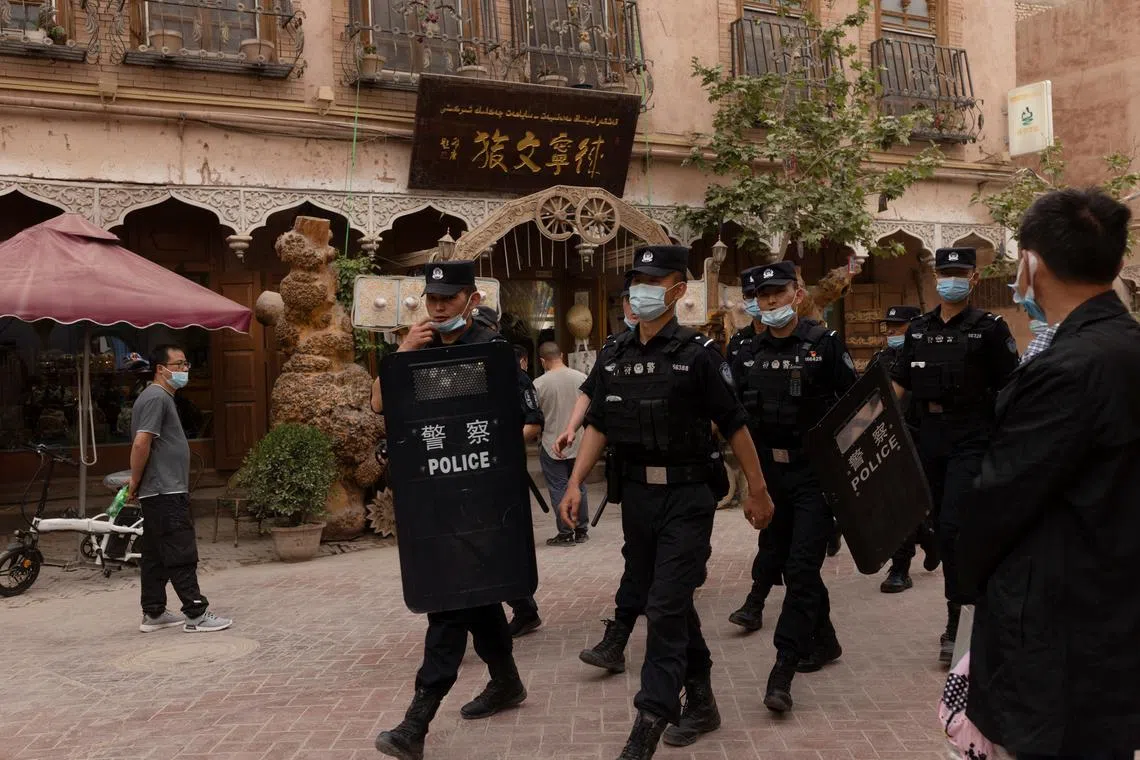 FILE PHOTO: Police officers patrol in the old city in Kashgar, Xinjiang Uyghur Autonomous Region, China, May 4, 2021. REUTERS/Thomas Peter/File Photo