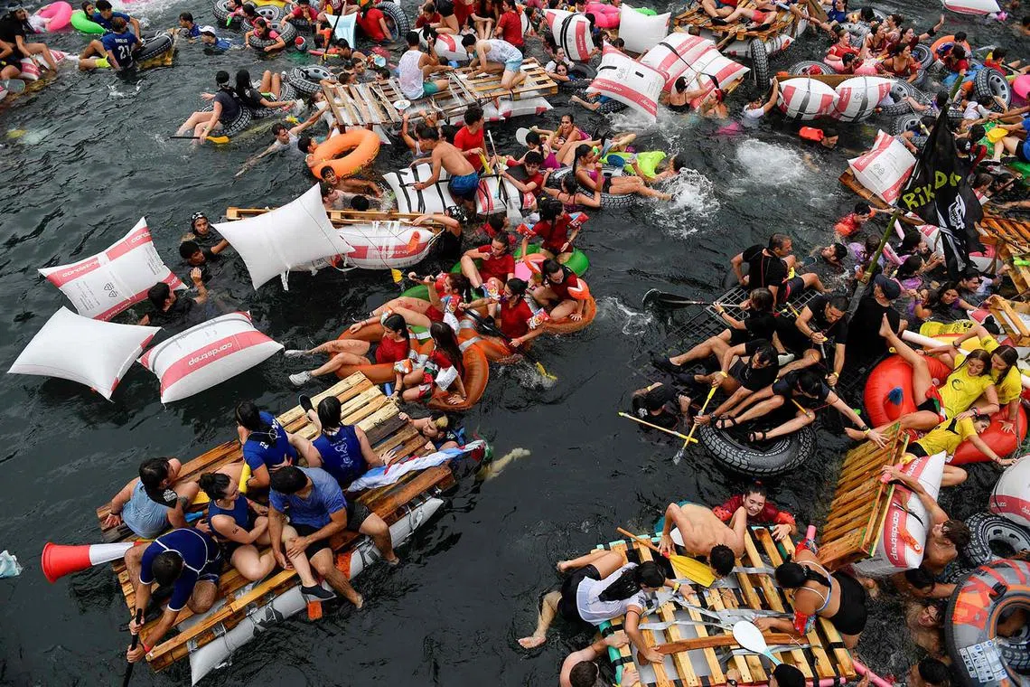 Revellers leaving the port on makeshift rafts before reaching La Concha Bay during the "Pirata Abordaia" (Pirate boarding) Festival in the Spanish Basque city of San Sebastian on Aug 12, 2024. 