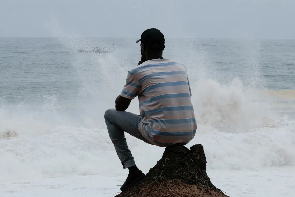 Latifou, a gay Togolese man who says he was forced onto a U.S. deportation flight to a third country before relocating to Ivory Coast, sits on a beach overlooking the Atlantic Ocean in Abidjan, Ivory Coast, September 21, 2026. REUTERS/Luc Gnago