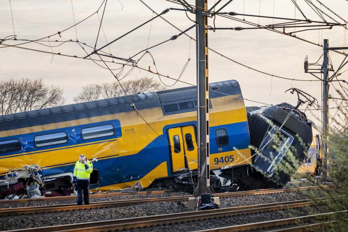 Emergency services work at a site of a derailed night train in Voorschoten, The Netherlands on 04 April 2023. One person has died and several people were seriously injured after a passenger train collided with construction equipment on the tracks. A freight train was also involved in the accident. 