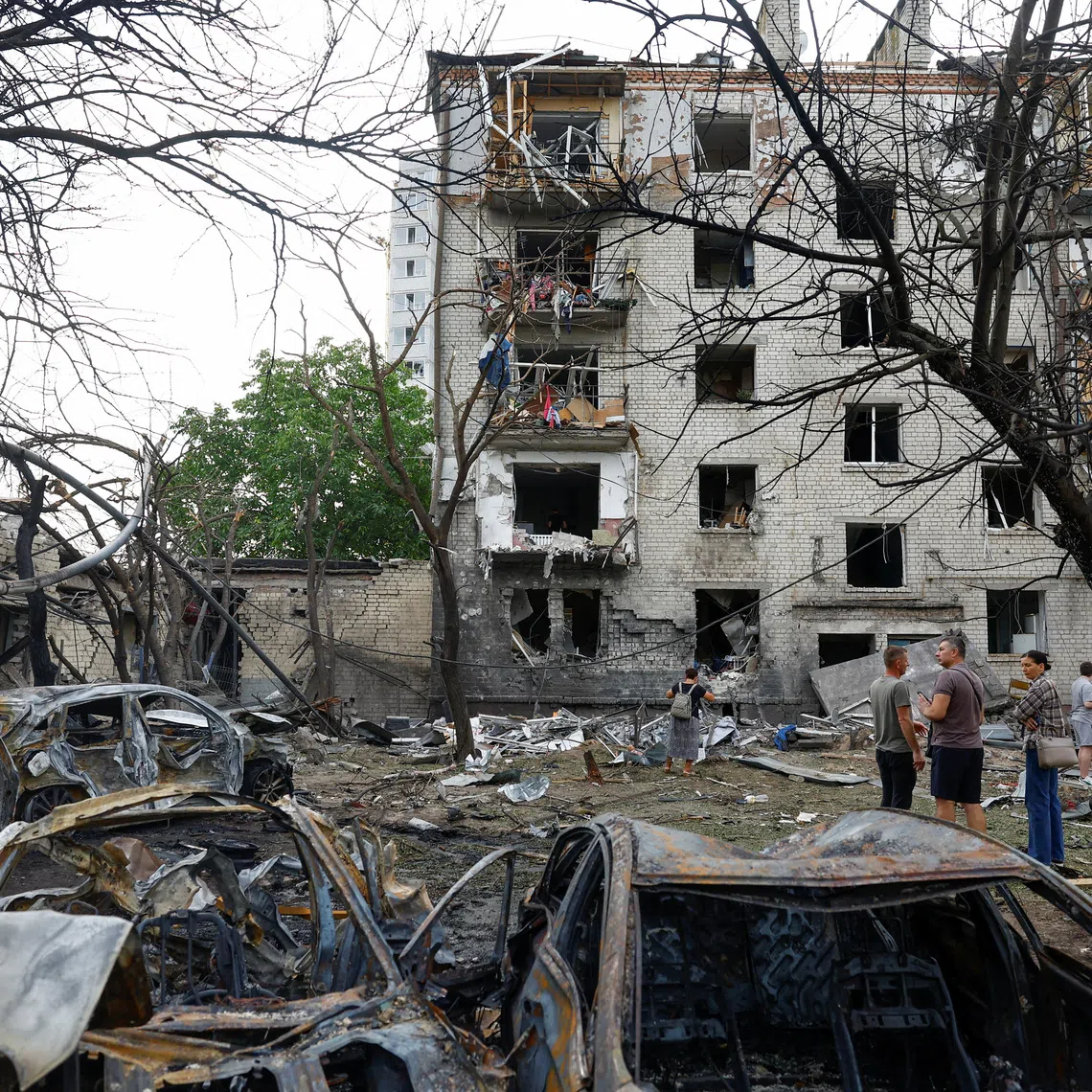 Residents stand in front of their apartment building damaged by a Russian missile strike in the town of Boryspil, amid Russia's attack on Ukraine, in Kyiv region, Ukraine September 1, 2026. REUTERS/Valentyn Ogirenko