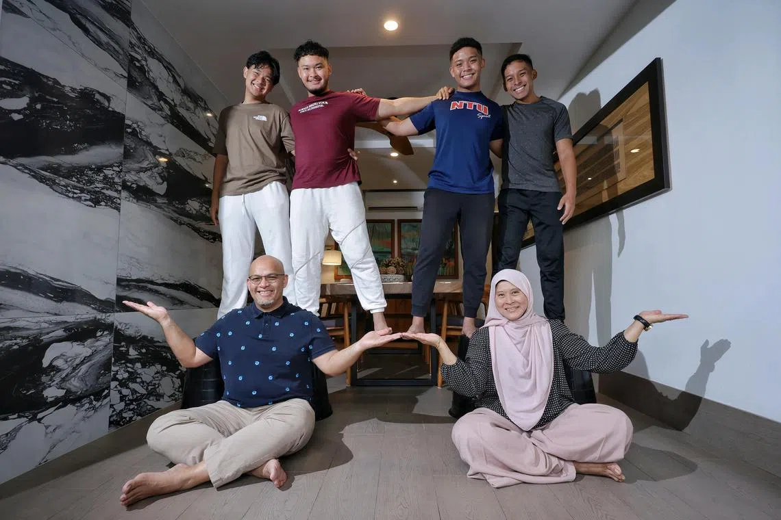 ST20241120_202468000435 Kevin Lim/ syparent/ Coach and counsellor Effendy Ibrahim (seated, left), 51, with his wife Madam Suliha Mohamed Yusoff, 51, and sons (from left) Fatih Hamdani, 17, Adib Rifa'i, 22, Amirul Haziq, 23, Naufal Zahin, 24, at home on Nov 20, 2024. Sunlife story on parenting and how to strike a balance between tiger parenting and being too soft.