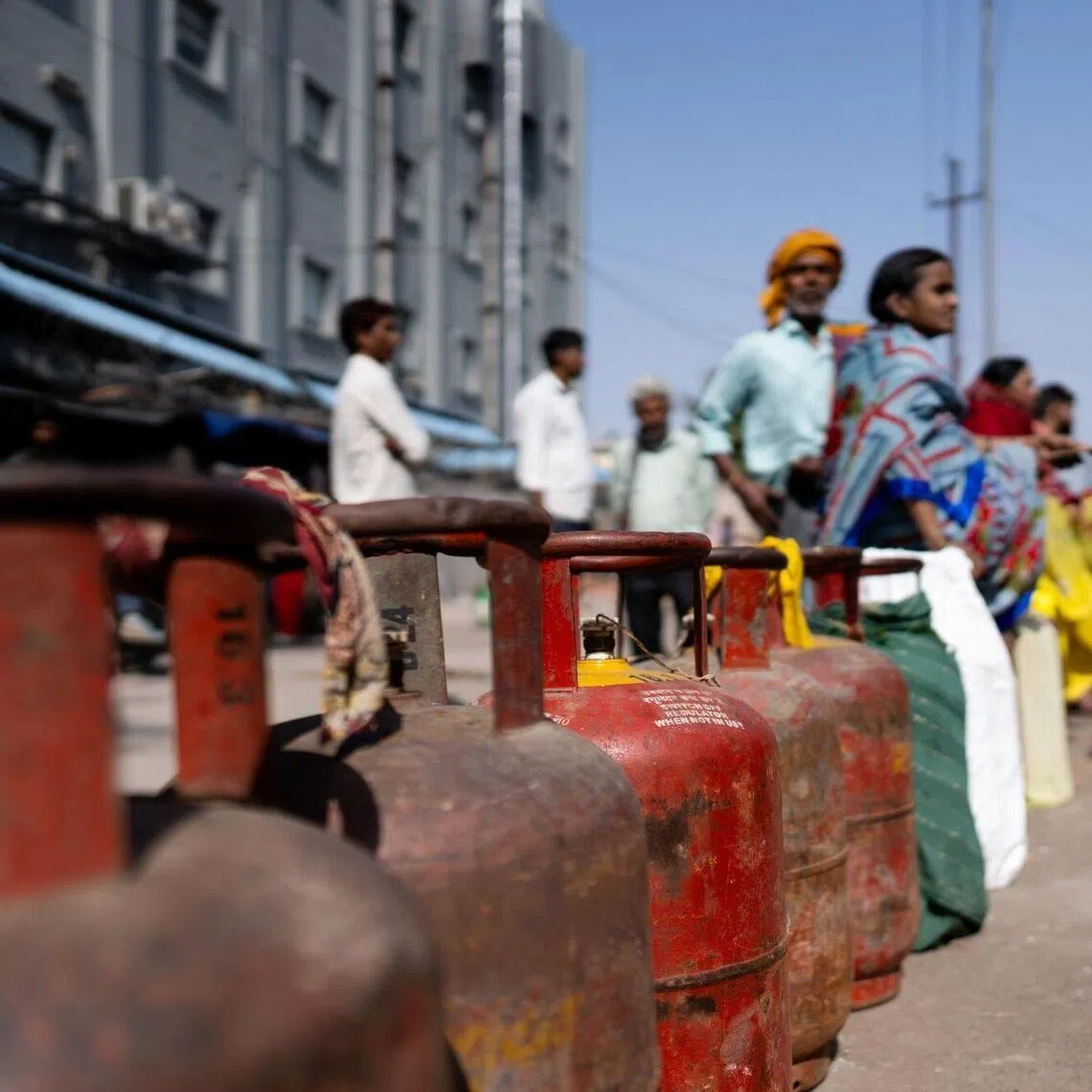 Buyers queue for liquefied petroleum gas (LPG) at a depot in Noida, Uttar Pradesh, India, on Monday, March 16, 2026. India is the second-largest importer of LPG in the world and is suffering acute shortages of the fuel, used in cooking gas and industrial processes.