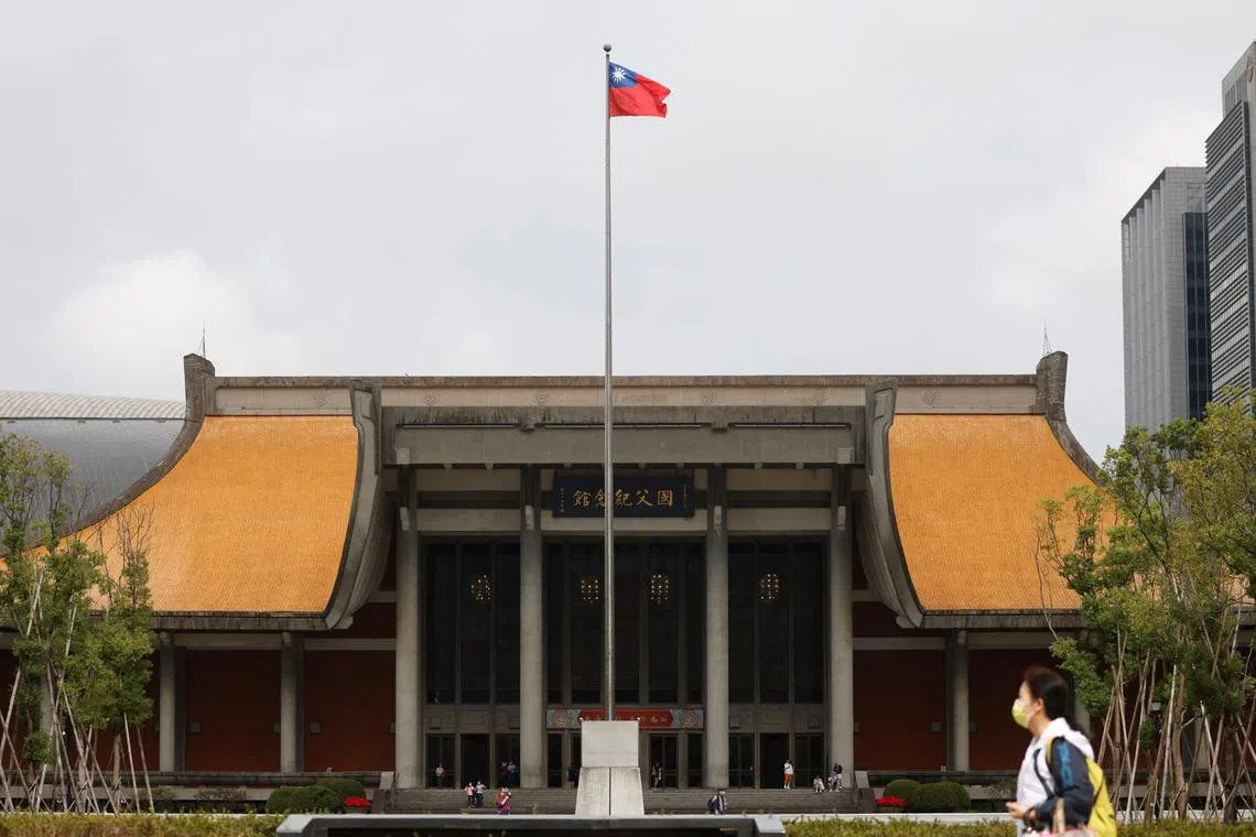 People walk near a fluttering Taiwanese flag outside the Sun Yat-Sen Memorial Hall in Taipei, Taiwan November 16, 2023. REUTERS/Carlos Garcia Rawlins/File Photo
