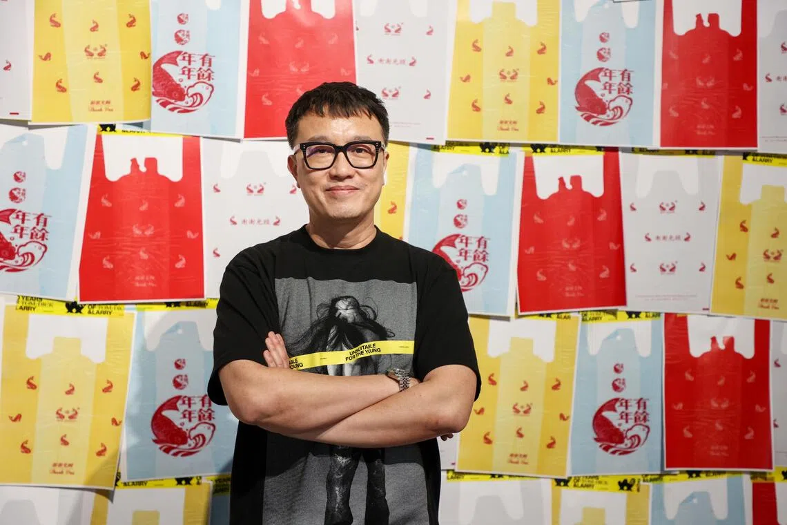 Larry Peh with the plastic bag with the red carp he designed.