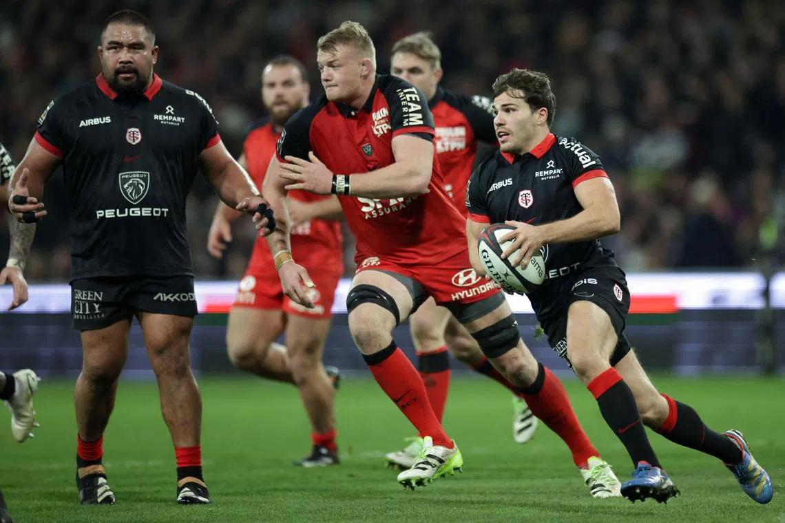 Toulouse's French scrum-half Antoine Dupont runs with the ball during the French Top 14 rugby union match between Stade Toulousain Rugby (Toulouse) and Rugby Club Toulonnais (Toulon) at the Ernest-Wallon Stadium.