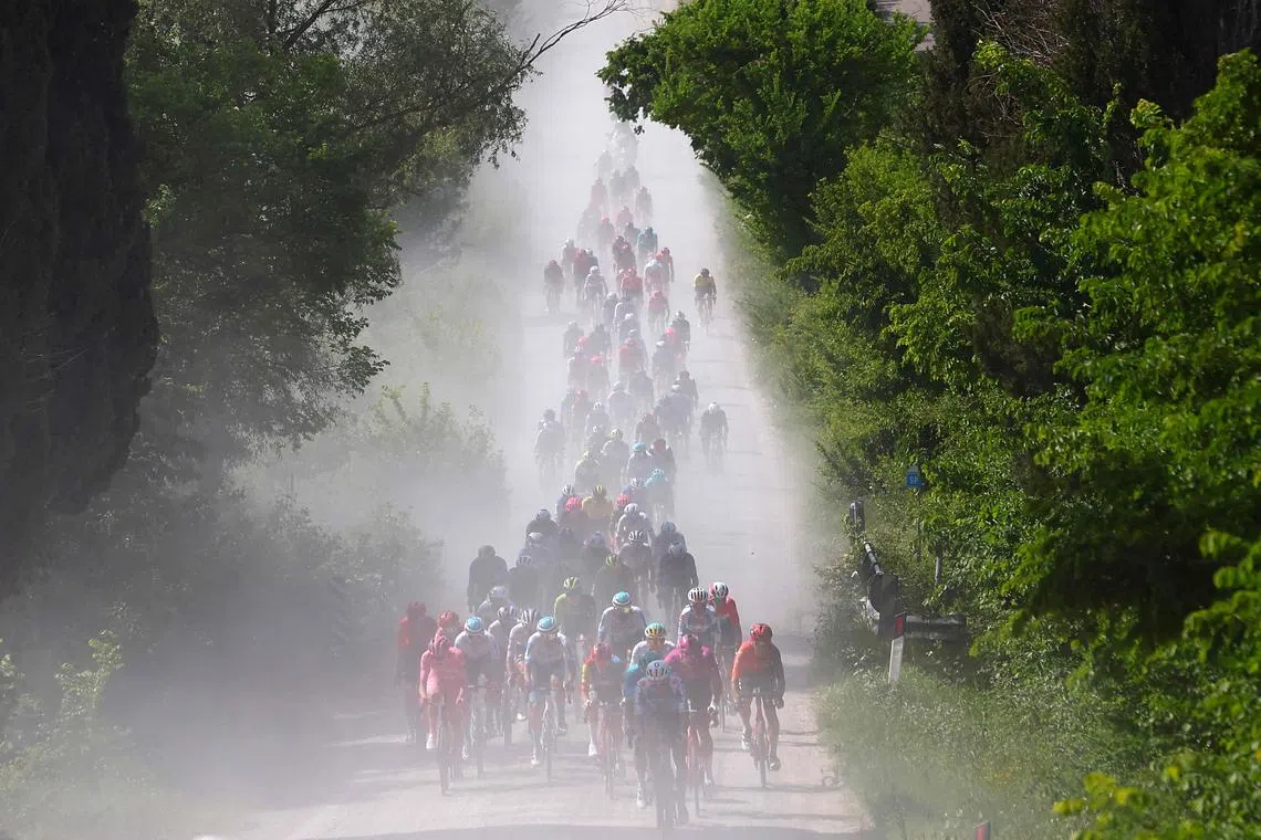A pack of cyclists riding past Tuscany, Italy, during the 6th stage of the 107th Giro d'Italia cycling race, on May 9, 2024. 