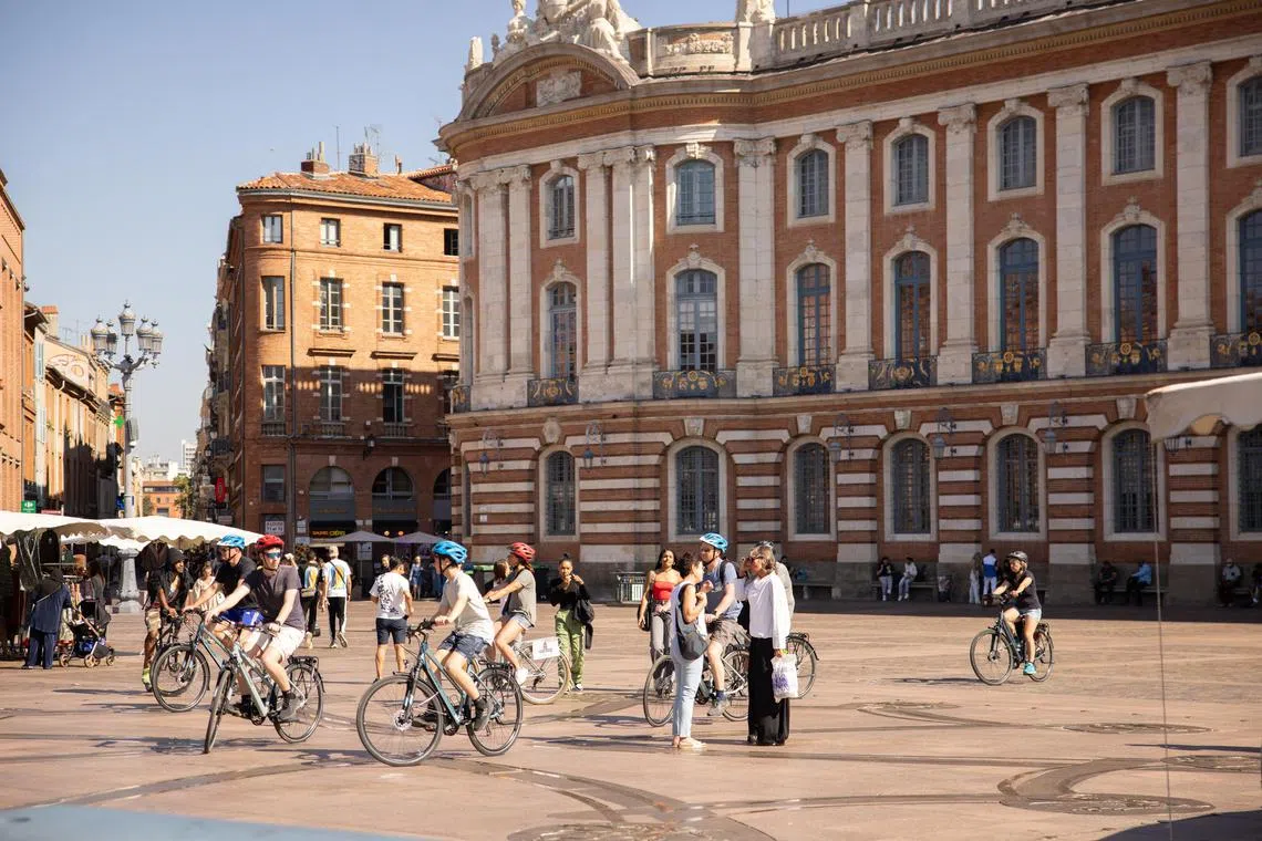 Cyclists in Toulouse, France, in October 2023. Toulouse is an eminently bikeable town: dedicated lanes for vŽlos run everywhere, with myriad signs and arrows to help. (Pattie Fellowes/The New York Times)