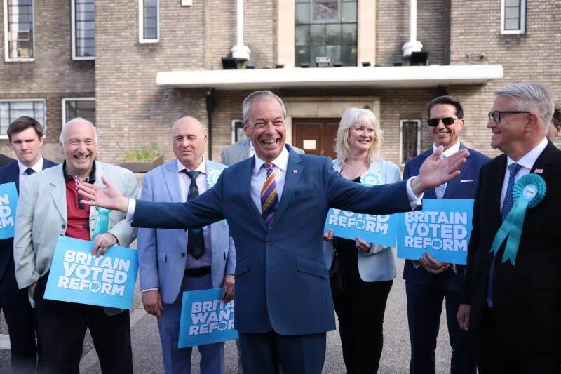 Reform Party leader Nigel Farage (centre) arrives at Havering Town Hall in London, Britain, on May 8, 2026.