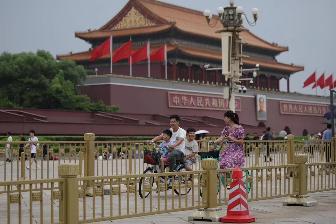 epa11479485 People ride a bicycle near Tiananmen Square as China's communist party holds its third plenum in Beijing, China, 15 July 2024. China, 15 July 2024. The third plenum of the Chinese Communist Party's central committee will be held in Beijing for four days, from 15 to 18 July 2024.  EPA-EFE/ANDRES MARTINEZ CASARES