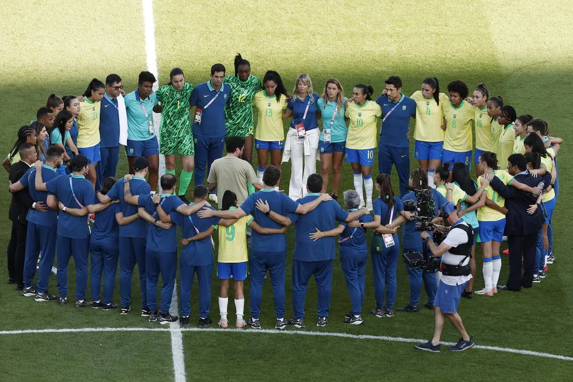 Brazil coach Arthur Elias with players and staff in a huddle after the final loss to the United States on Aug 10. 