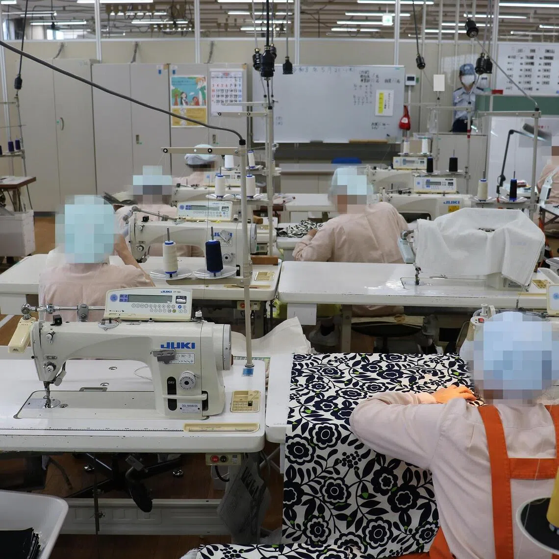 Inmates working with sewing machines at Tochigi Prison, Japan's largest female correctional facility.