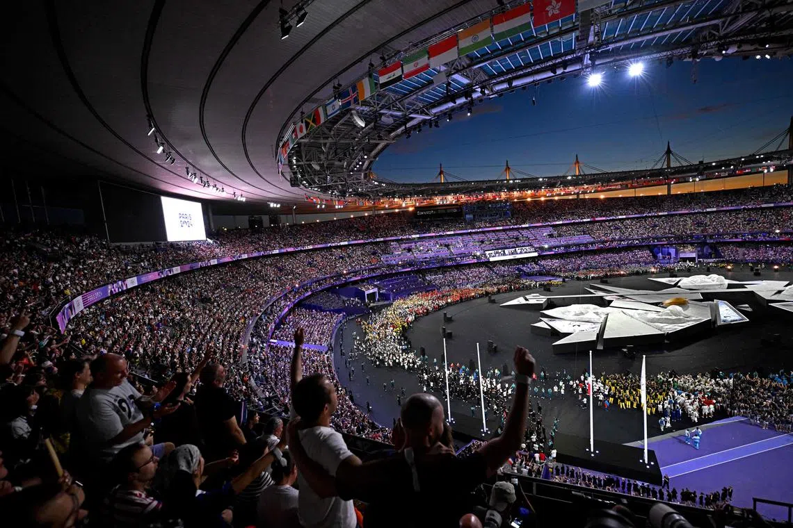Spectators cheer during the closing ceremony of the Paris 2024 Olympic Games at the Stade de France, in Saint-Denis, on Aug 11, 2024.