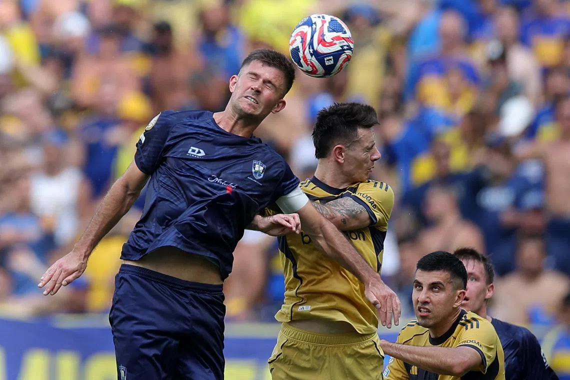 Auckland City's Mario Ilich in action with Boca Juniors' Malcom Braida.