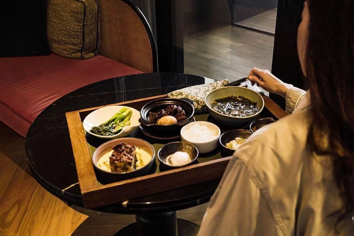 Postpartum woman eating nourishing food at DeRama Singapore