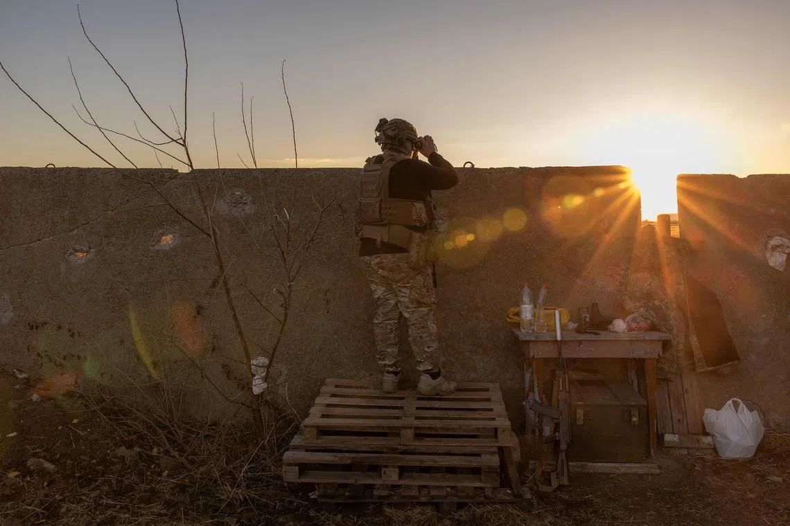 A Ukrainian soldier watches an area of the Dnipro river,in an undisclosed location on Nov 6, 2023.