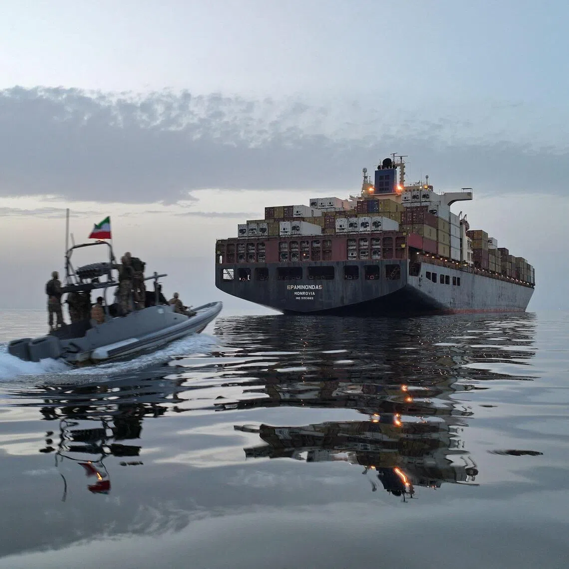 This photo obtained by AFP from the Iranian news agency Tasnim shows an Islamic Revolutionary Guard Corps (IRGC) boat allegedly taking part in an operation to seize ships attempting to cross the Strait of Hormuz, on April 21, 2026. Oil prices had been climbing earlier as investors worried about a lack of progress in ending the Middle East crisis, with Tehran keeping the Strait of Hormuz closed and the US maintaining a blockade of Iranian ports. (Photo by Meysam MIRZADEH / TASNIM NEWS / AFP) / 