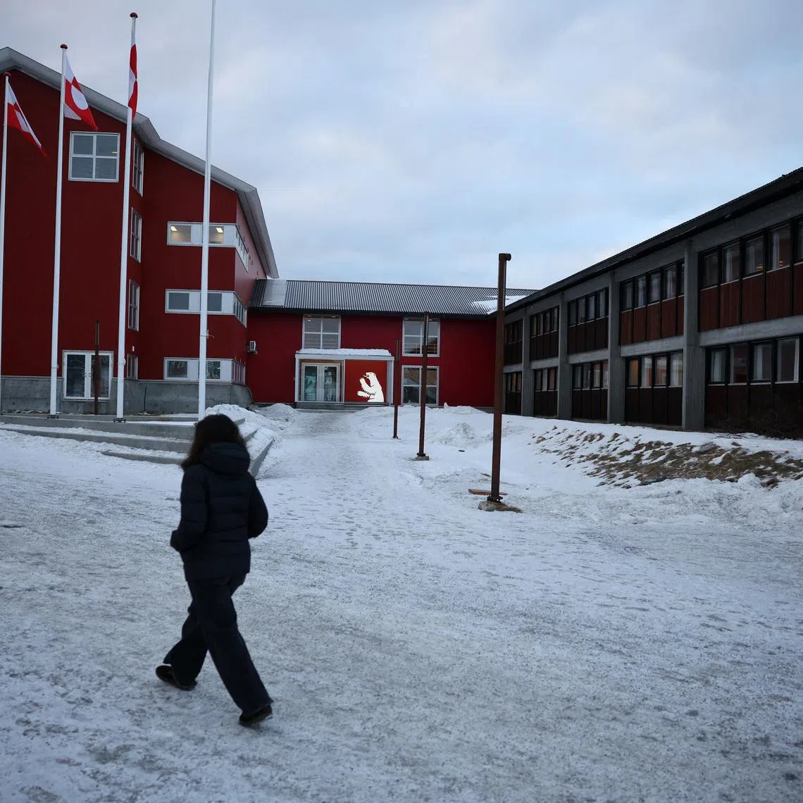 A person walks in front of the parliament in Nuuk, Greenland, February 2, 2026. REUTERS/Stoyan Nenov