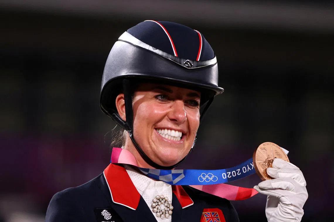 FILE PHOTO: Tokyo 2020 Olympics - Equestrian - Dressage - Team - Medal Ceremony - Equestrian Park - Tokyo, Japan - July 27, 2021. Charlotte Dujardin of Britain poses with her bronze medal REUTERS/Hamad I Mohammed/File Photo