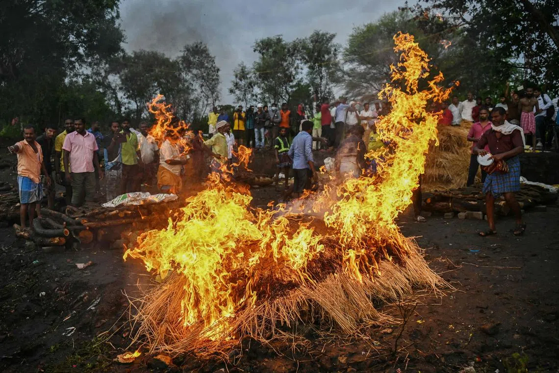 Family members perform last rites during funeral of victims who died after consuming toxic alcohol in Kallakurichi district of India's Tamil Nadu state on June 20, 2024.