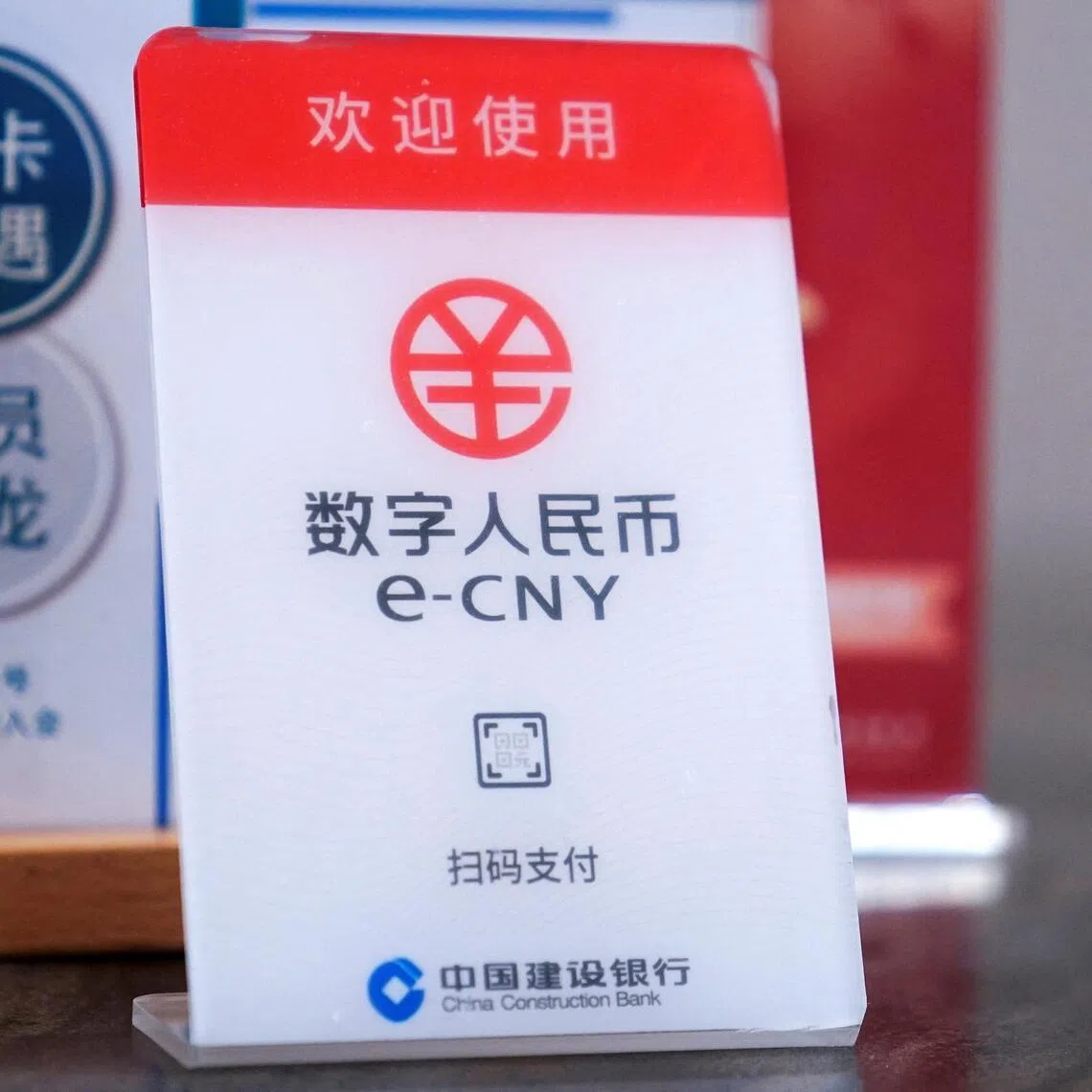 A sign indicating digital yuan, also referred to as e-CNY, is pictured at a shopping mall in Shanghai, China. 