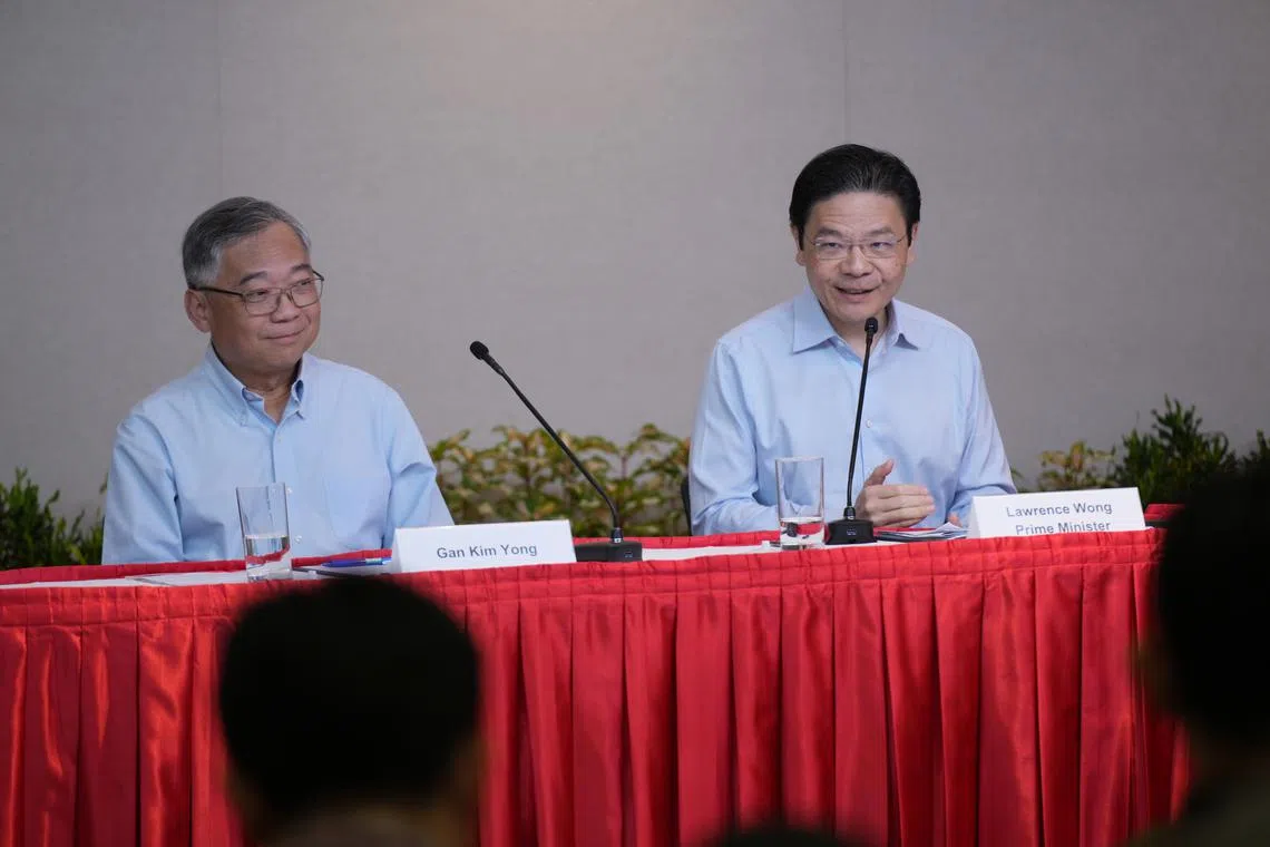 PM Lawrence Wong (right) and DPM Gan Kim Yong at a press conference on May 21.