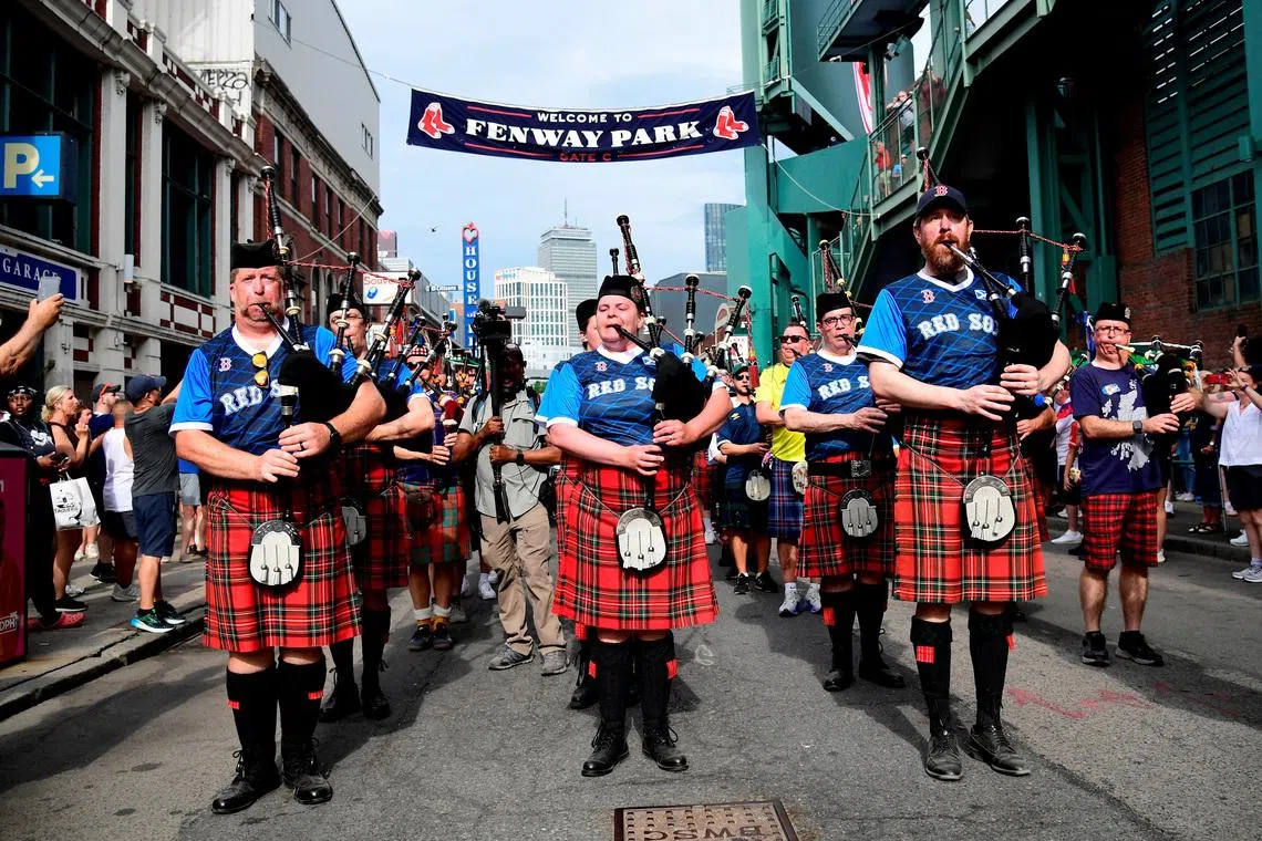 Soccer Football - FIFA World Cup 2026 - Scotland's Tartan Army march to Boston's Fenway Park baseball stadium - Boston, Massachusetts, U.S. - June 14, 2026 Scotland fans wearing kilts and playing the bagpipes during the march to Fenway Park IMAGN IMAGES via Reuters/Bob Dechiara