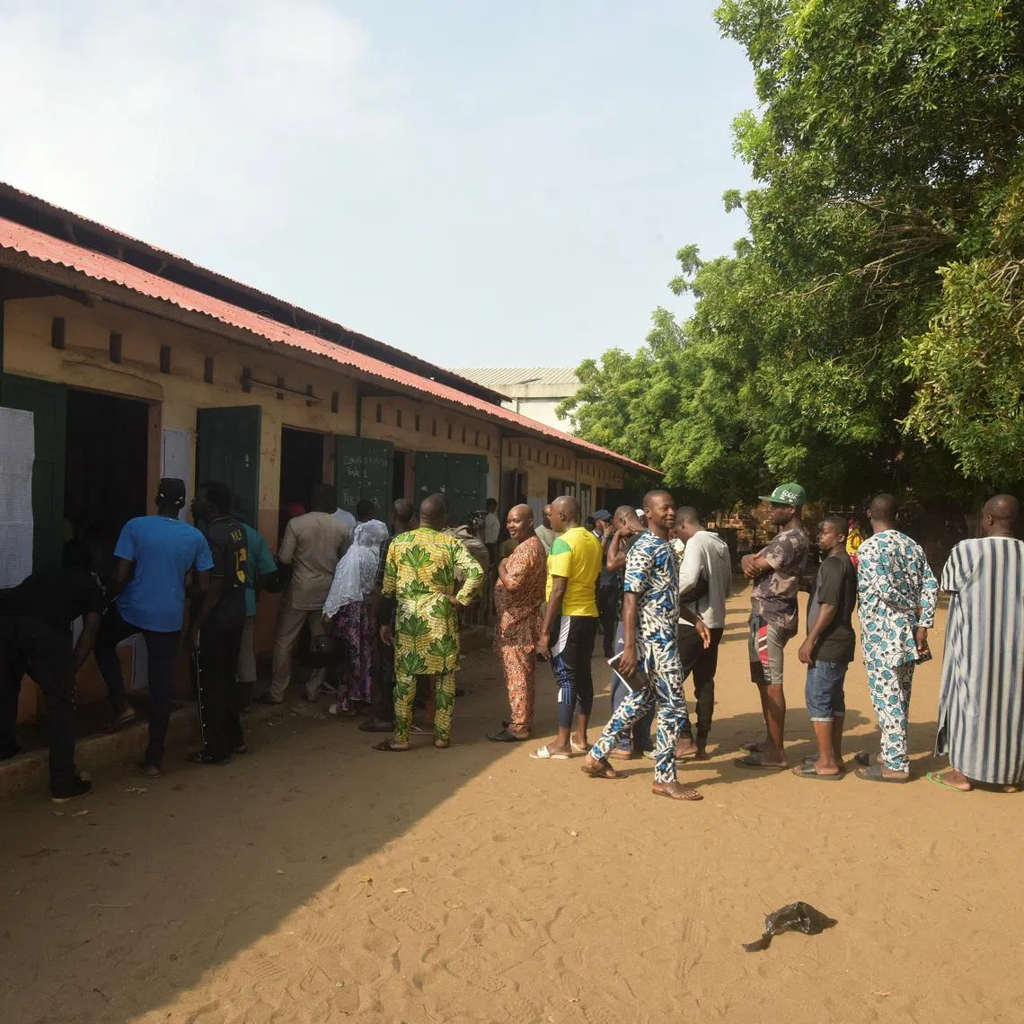 People wait in line to cast their vote at a polling station during the parliamentary election, in Cotonou, Benin, January 11, 2026. REUTERS/Charles Placide Tossou