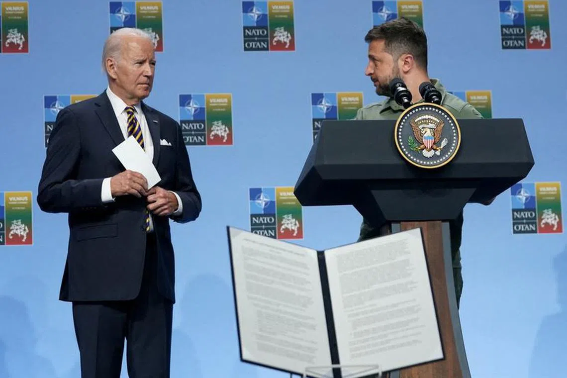 Ukraine’s President Volodymyr Zelenskiy speaks at an event, while U.S. President Joe Biden listens, as G7 leaders announce a joint declaration of support for Ukraine, as the NATO summit is held in Vilnius, Lithuania, July 12, 2023. REUTERS/Kevin Lamarque/File photo