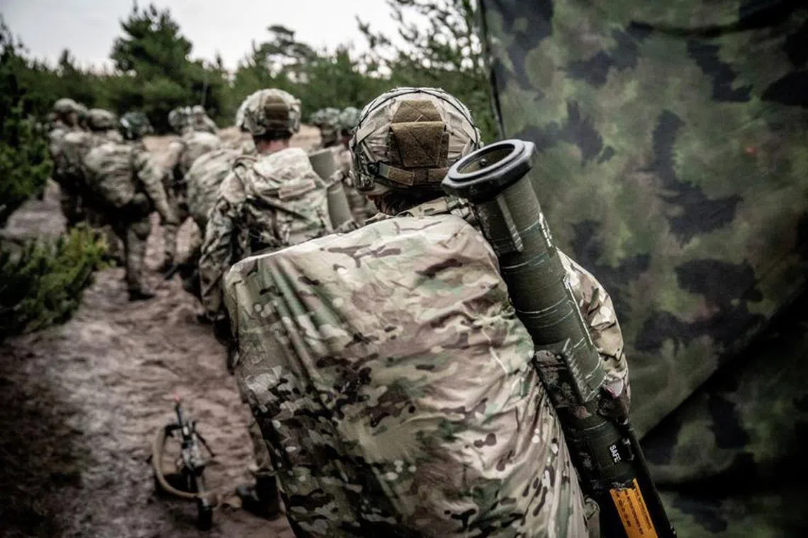 FILE PHOTO: Soldiers from the Schleswig Infantry Regiment on drill at the Oksboel Shooting and Training Ground, Jutland, Denmark, March 16, 2023. The regiment is one of four combat troop regiments under the Danish Army Command.   Ritzau Scanpix/Mads Claus Rasmussen via REUTERS/File Photo