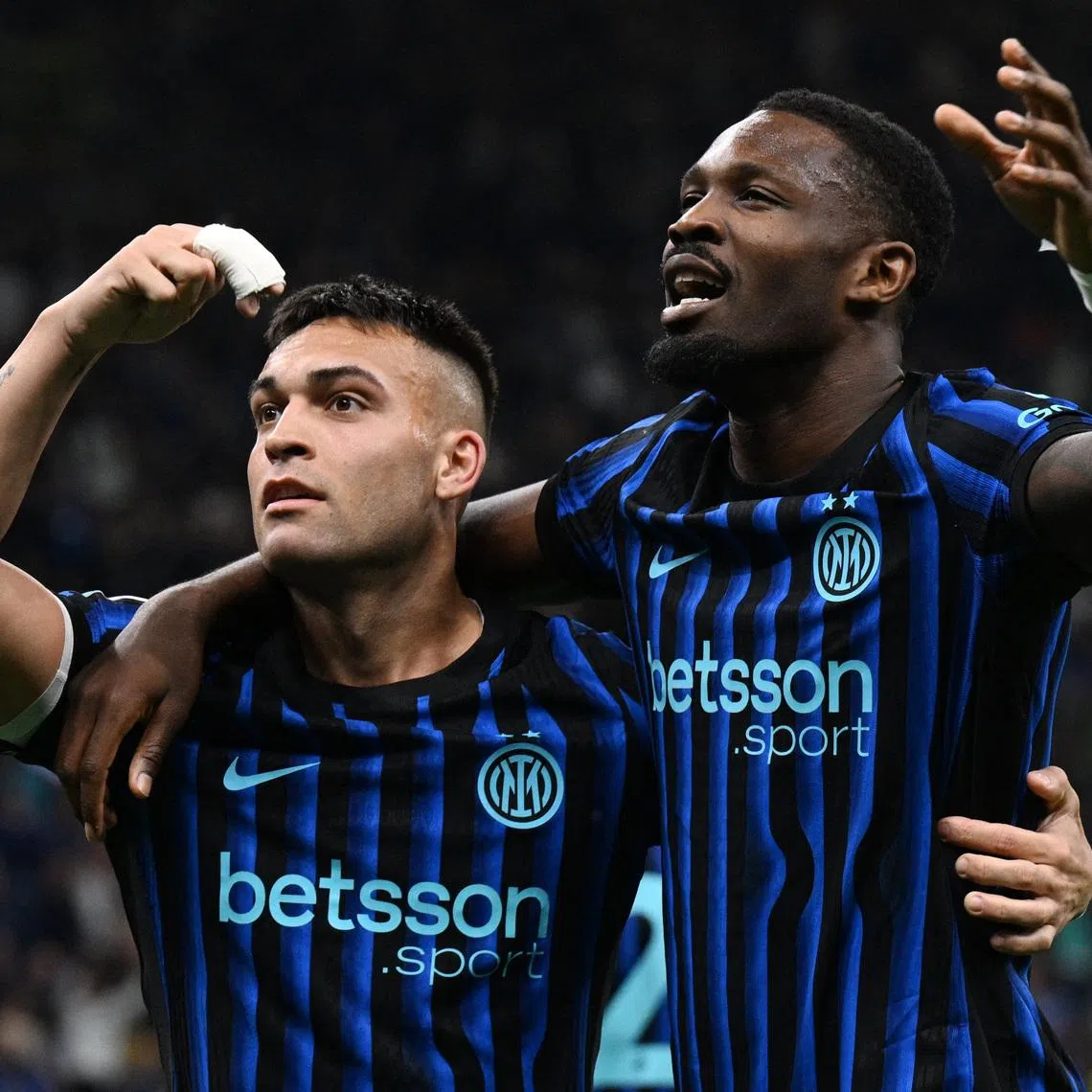 Soccer Football - Serie A - Inter Milan v AS Roma - San Siro, Milan, Italy - April 5, 2026 Inter Milan's Lautaro Martinez celebrates scoring their third goal with Marcus Thuram REUTERS/Jennifer Lorenzini