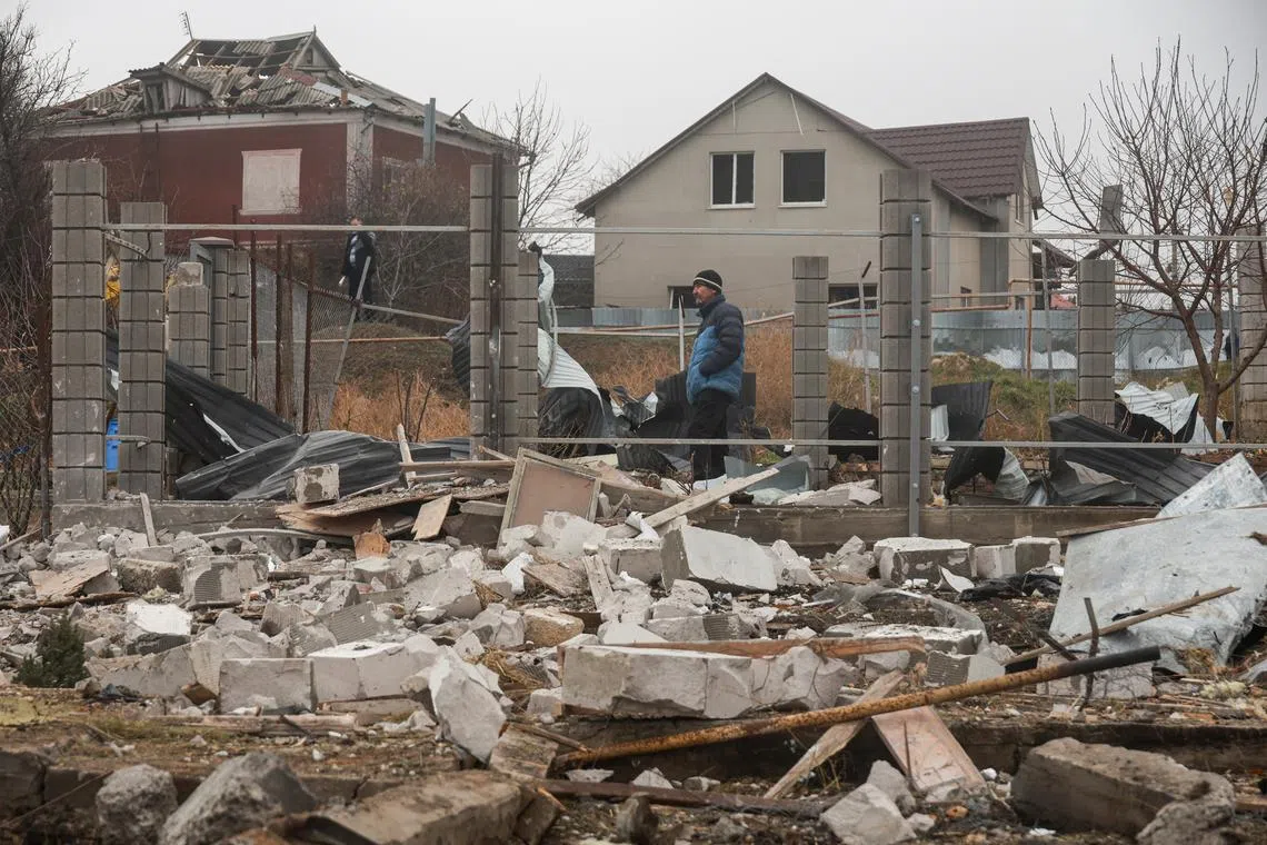 Residents stand next to their houses damaged by a Russian missile strike, amid Russia's attack on Ukraine, on the outskirts of Odesa, Ukraine November 28, 2024. REUTERS/Nina Liashonok/File Photo