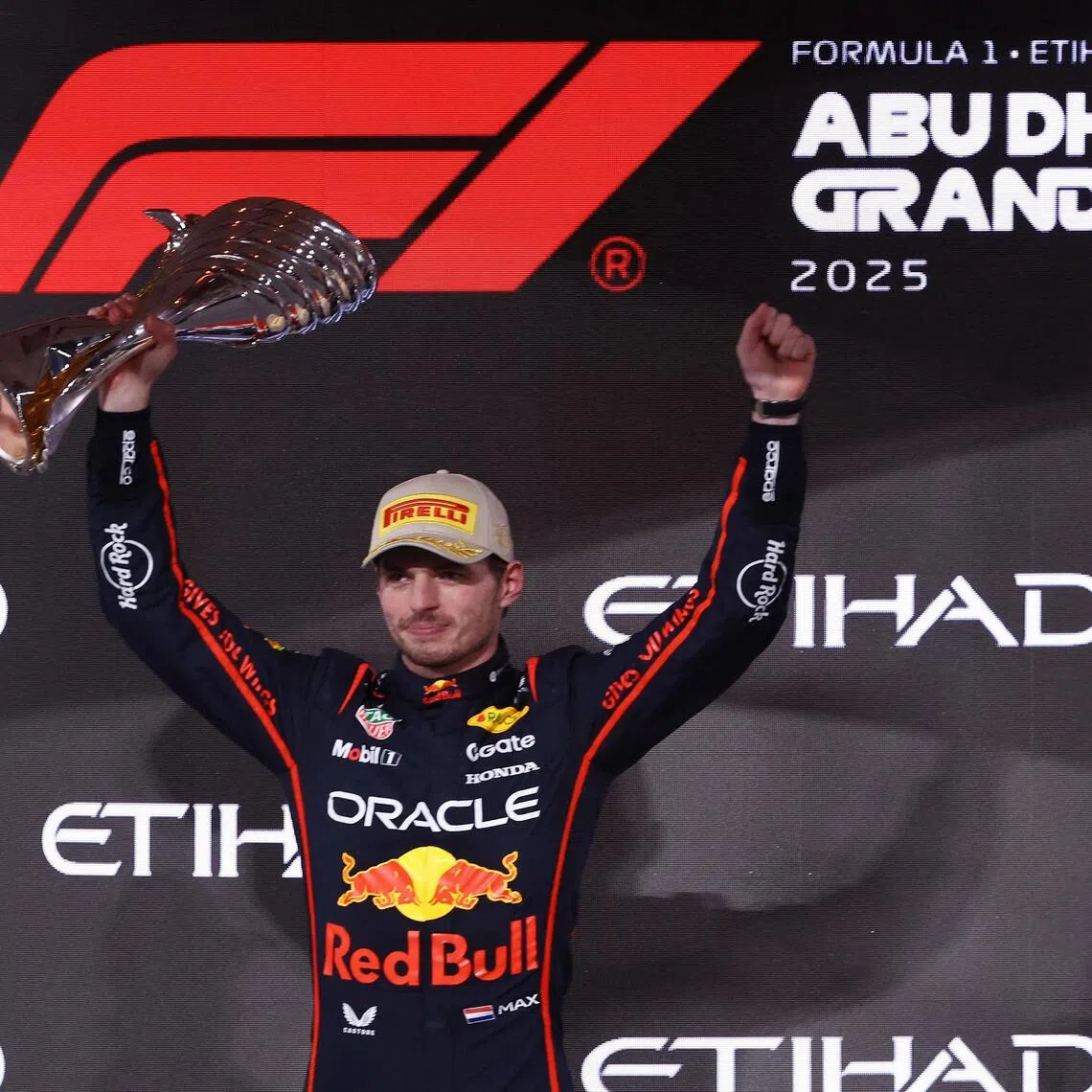 Red Bull's Max Verstappen celebrates on the podium after winning the Abu Dhabi Grand Prix.