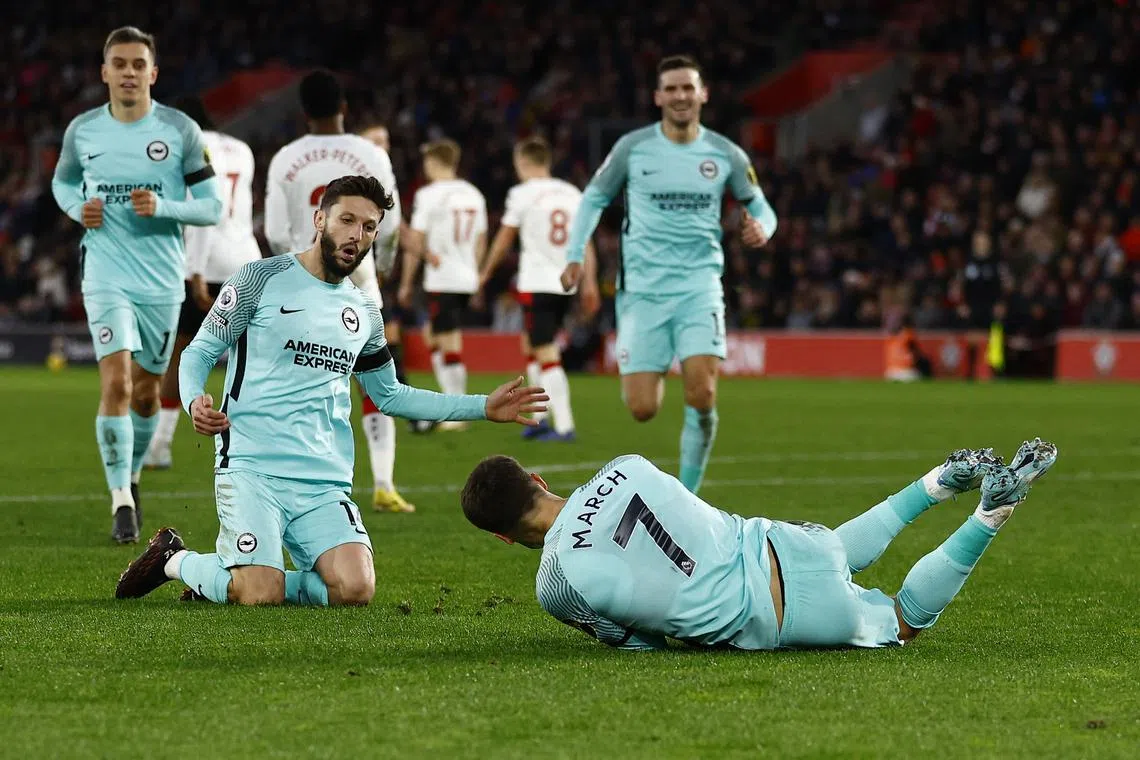 Brighton & Hove Albion's Solly March celebrates scoring their third goal with Adam Lallana.
