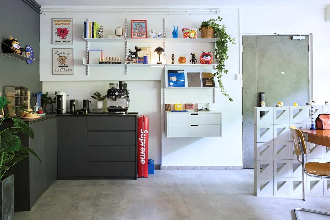 Wall shelves at the coffee corner showcase the owner’s collectibles.