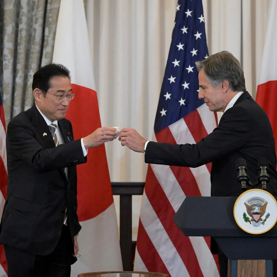 U.S. Secretary of State Antony Blinken (right) toasts Japanese Prime Minister Fumio Kishida at a State Department luncheon.