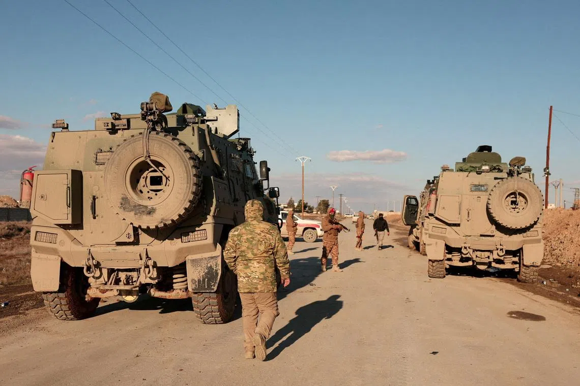 FILE PHOTO: Military members gather near Raqqa prison, where the Syrian army is besieging SDF members after the army took control of the city of Raqqa, Syria January 19, 2026. REUTERS/Mahmoud Hassano/File Photo