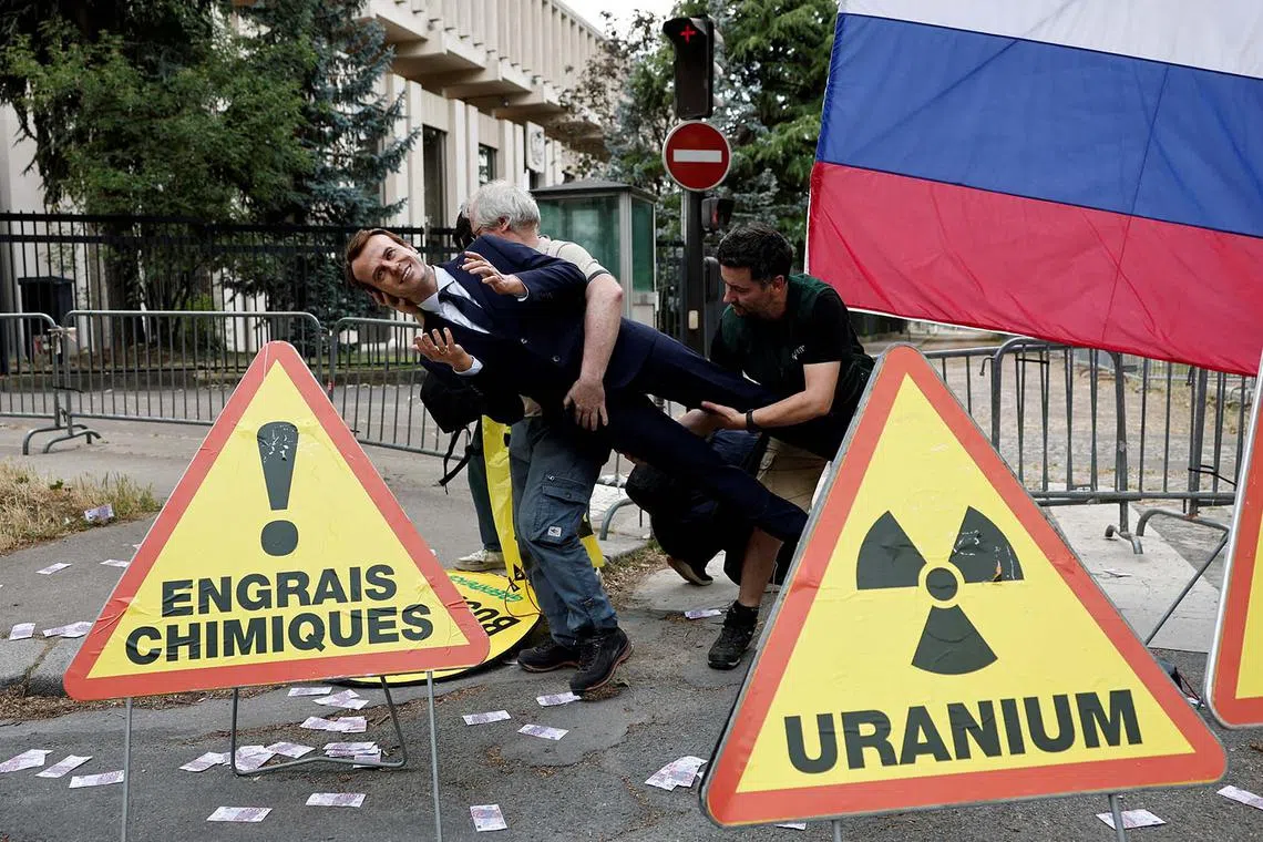 Greenpeace activists installing a wax statue of French President Emmanuel Macron borrowed from the Grevin Museum without permission, to denounce what they call France's continued commercials ties with Russia despite the war in Ukraine, in front of the Russian Embassy in Paris, France, June 2, 2025. 
