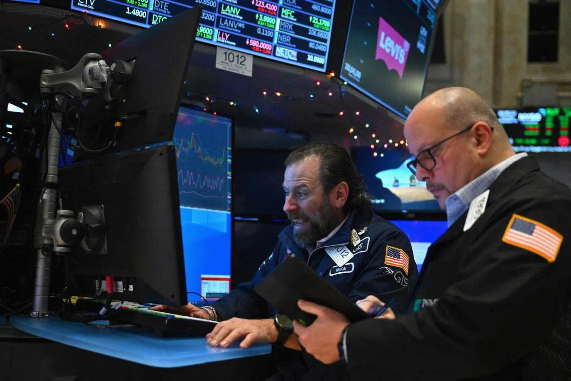 Traders work on the floor of the New York Stock Exchange, during morning trading, in New York City. 