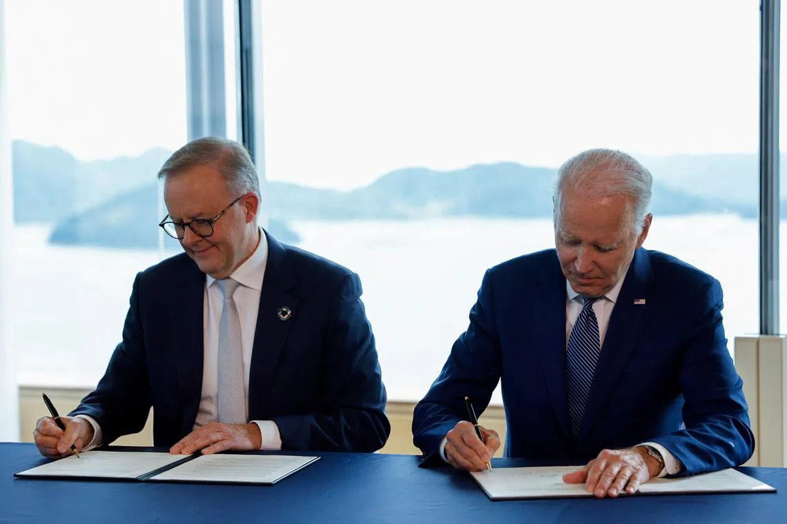 Australian PM Anthony Albanese (left) and US President Joe Biden sign a statement of intent on climate critical minerals and clean energy during the G7 summit on May 20.