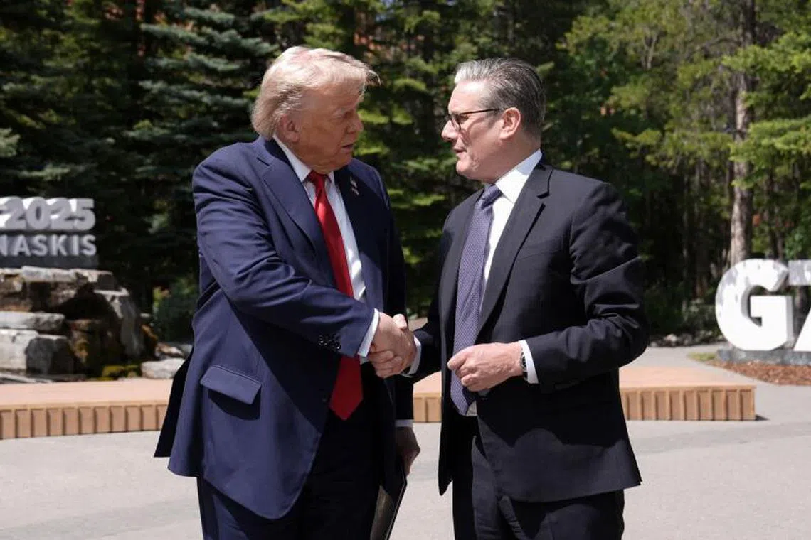 US President Donald Trump (L) and British Prime Minister Keir Starmer shake hands as they speak to reporters during the Group of Seven (G7) Summit at the Pomeroy Kananaskis Mountain Lodge in Kananaskis, Alberta, Canada on June 16, 2025. (Photo by Stefan Rousseau / POOL / AFP)